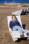 young-woman-wearing-warm-clothes-resting-sunbed-beach_262388-2382.jpg